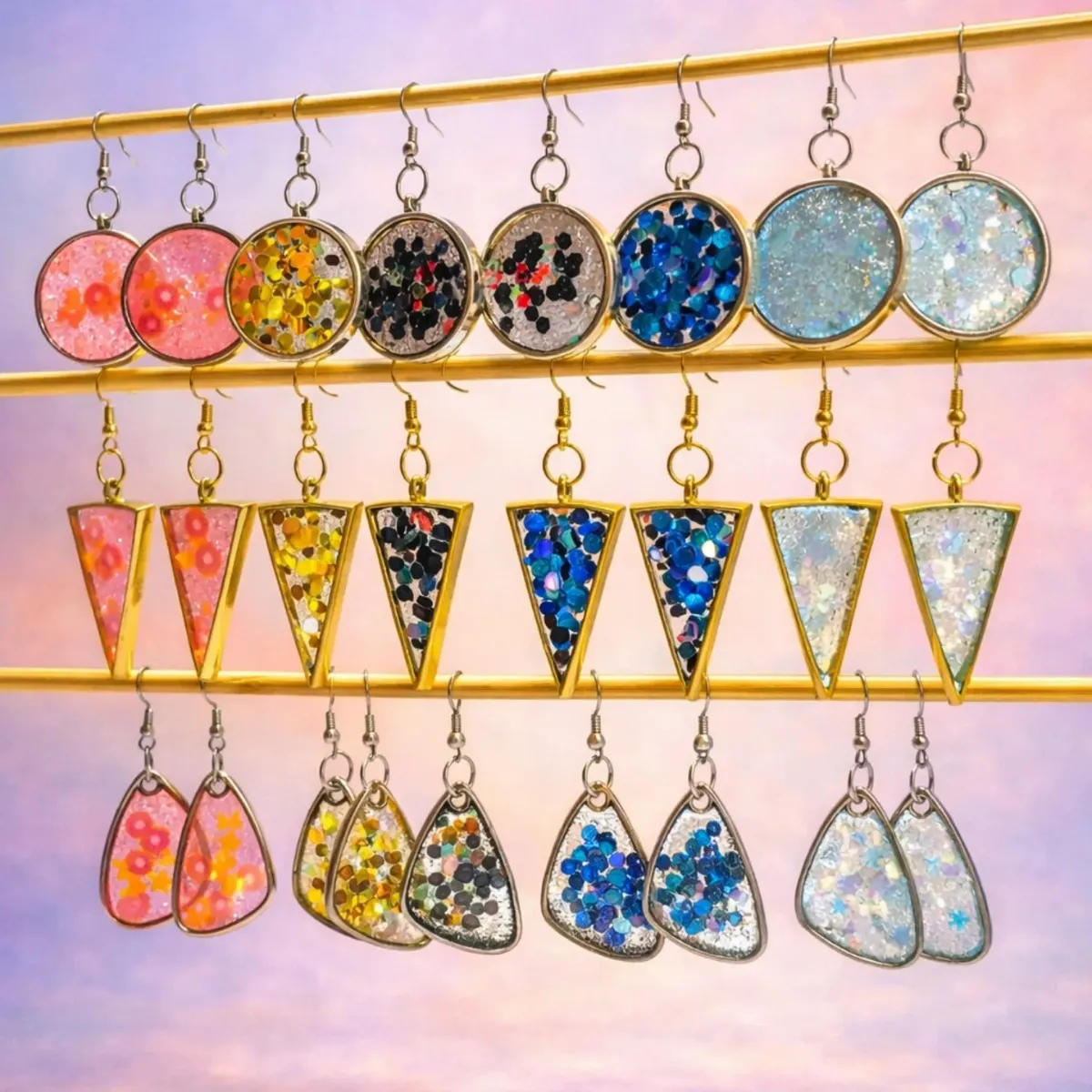 Three rows of matching resin drop earrings on a gold rail