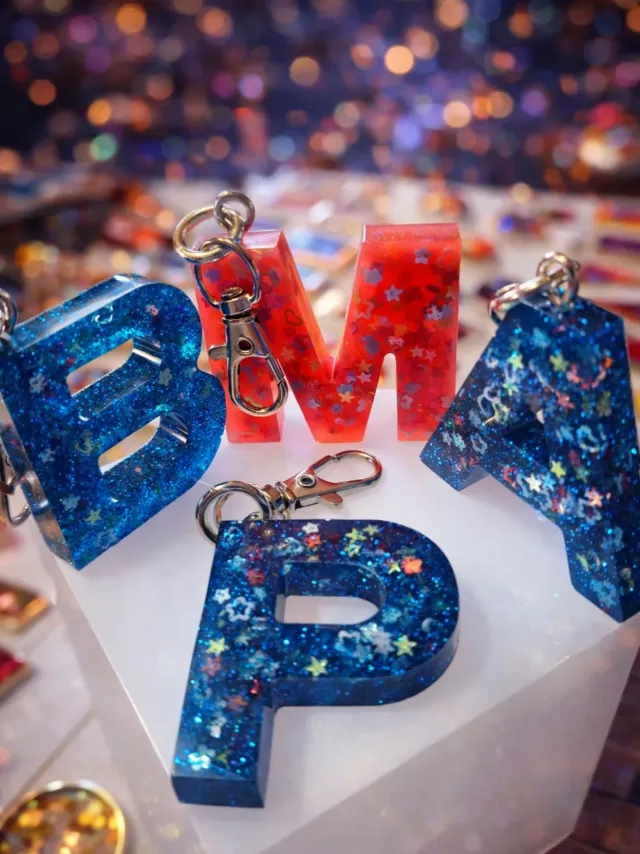 Blue glitter letter keychains spelling B, M and P